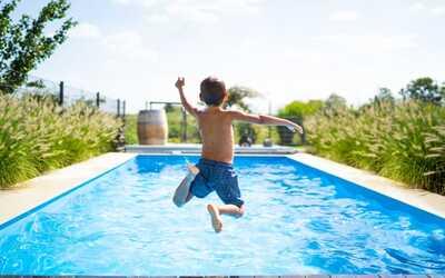 boy jumping in swimming pool